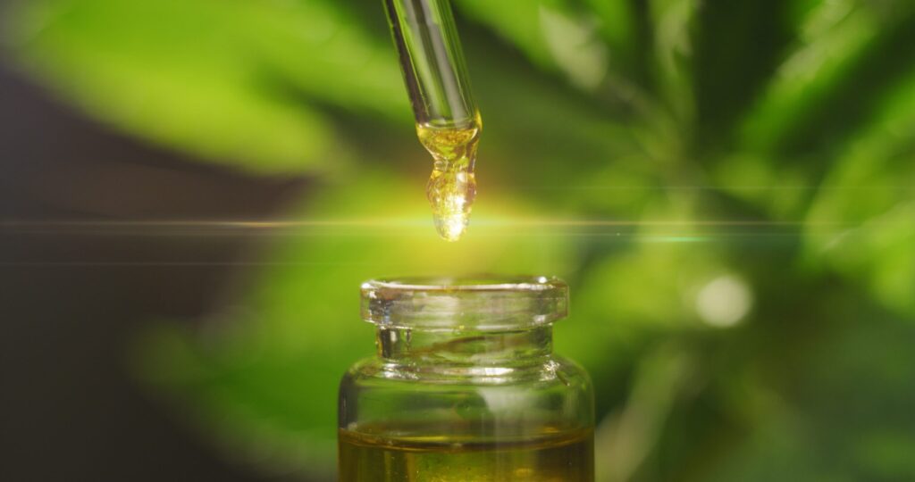 Nature's Green House explains the differences between hemp and CBD oils they offer while a specialist uses a dropper to fill a tincture bottle